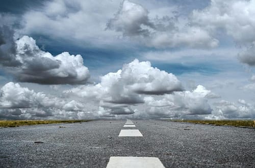 gray rolled asphalt road under cloudy sky